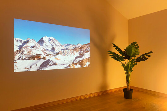 Alps under snow picture on the wall of a yellow room