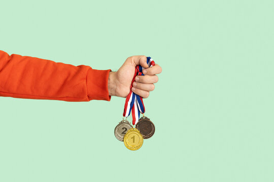 Person holding medals. Success, competition, winner, award.