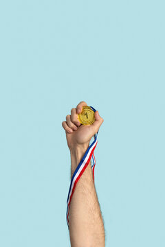 Person holding first prize gold medal. Success, competition, winner.
