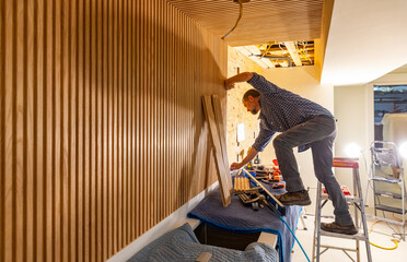 Blue Collar worker Carpenter building Vertical wood paneling wall 