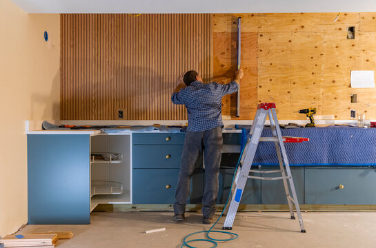 Home Construction worker using level tool