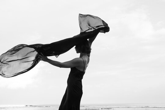 Abstract female dance on beach in sunrise