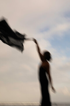 Abstract female dance on beach in sunrise
