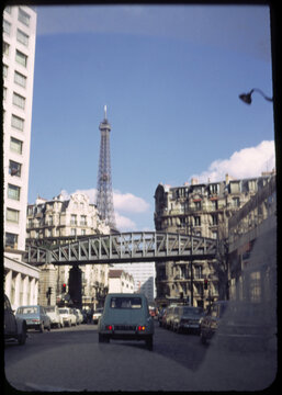 70's film photo. Cityscape of a street of Paris with Eiffel Tower