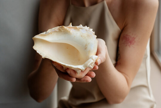 Woman holding a seashell