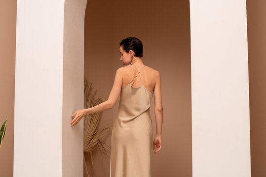 Elegant Woman Posing in Arched Doorway 