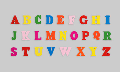 wooden letters of the English alphabet multi-colored on a grey background