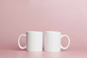white cups for tea or coffee on a pink background