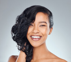 Hair care, woman and smile in studio for beauty with curly treatment, shampoo shine or glowing...
