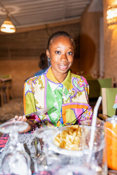 Woman Sitting at Table With Plate of Food