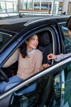 Woman getting the car keys for a test drive