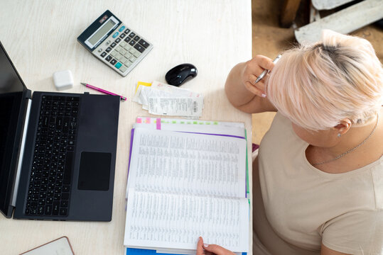 Accountant working at a laptop in the office among documents