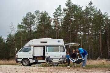 Father sets up camp with his sons
