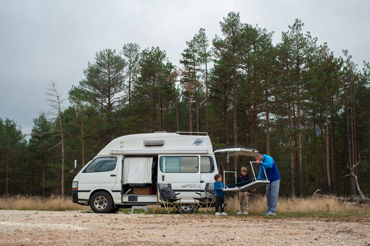 The family sets up camp by the van