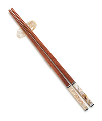 Reusable wooden chopsticks on chopstick rest