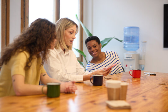Office Colleagues Sharing Content on Phone