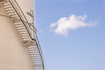 Stairs on the side of a gas storage tank.