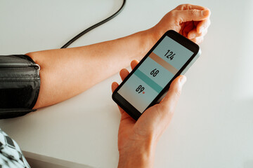 man reading his blood pressure on his smartphone