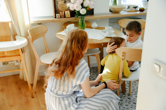 mother with children in the kitchen