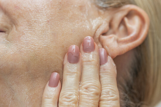 Mature Woman Applying Face Serum