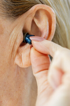 Person Inserting Hearing Aid

