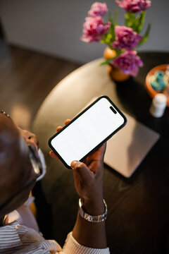 A man uses a mobile phone with white screen