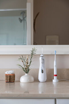 Single Toothbrush next to sink  still life water flosser still life