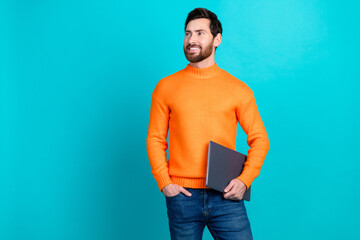 Photo of attractive young man wear stylish clothes hold netbook look empty space isolated on...