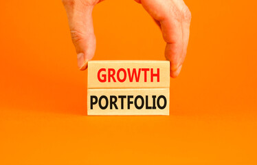 Growth portfolio symbol. Concept words Growth portfolio on beautiful wooden block. Beautiful orange paper background. Businessman hand. Business Growth portfolio concept. Copy space.