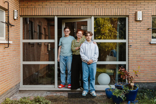 door portrait of mother with her teenage boys