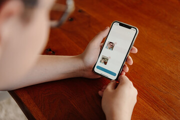 Teenager holding phone with screen visible
