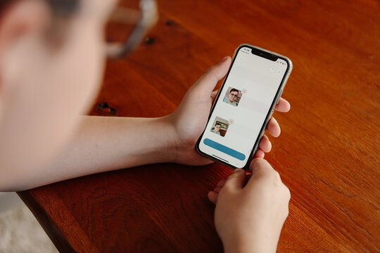 Teenager holding phone with screen visible