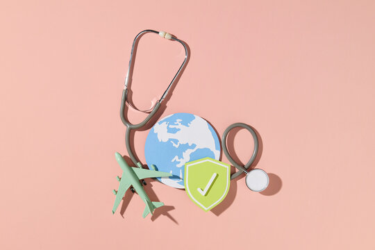 Stethoscope on passport with medical insurance shield symbol