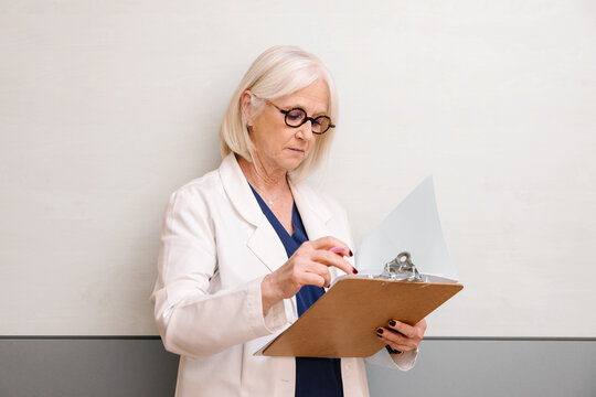 Senior medical professional reviewing documents