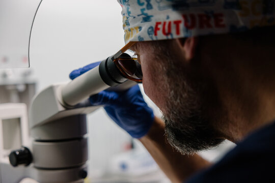 Real scientist engaged in microscope research