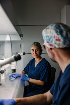 Smiling female scientist engaging in laboratory work