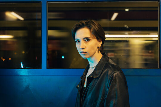 Woman with piercing gaze at train station