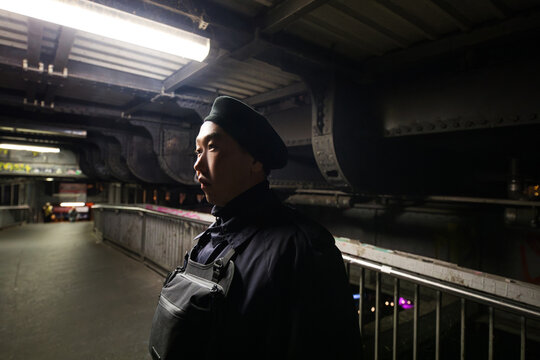 Man with Beret and Chest Bag at Subway Station
