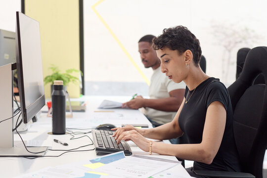 Dedicated Employee Focused on Computer Task in Collaborative Office