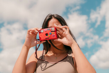 Teen taking an analog picture with a camera