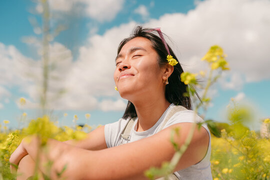 Smiling asian woman portrait with yellow flowers
