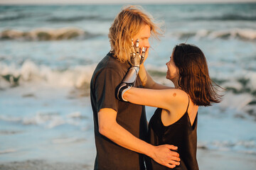 Portrait of a couple in love hugging at the seaside during sunset