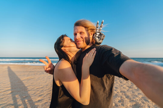 Wide angle ugc selfie of couple in love at the beach on sunny day