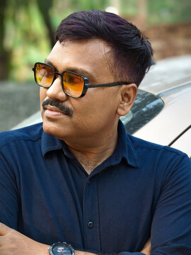 Middle aged Indian man with happy expressions at outdoors