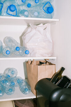 Sorted plastic waste rests on shelves before being sent to recycling