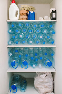 Sorted plastic waste rests on shelves before being sent to recycling