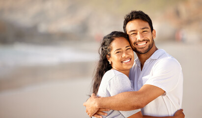 Obraz premium Portrait, smile and couple hug at beach on holiday, vacation or travel together outdoor in summer. Face, happy man and woman embrace at ocean for care, love and support for connection on date at sea
