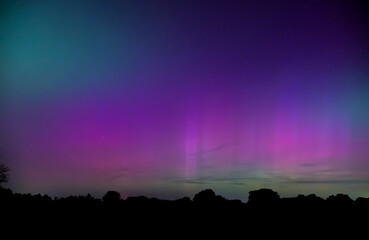 Northern Lights in green, pink and purple over rural Oklahoma sky in May 2024