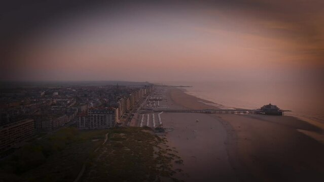 Aerial view of sunset, sandy beaches and ocean in Blankenberge, Flanders region, Belgium.