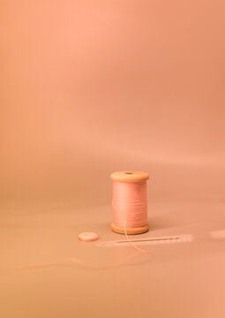 Vintage-Inspired Sewing Equipment on a Peach-Colored Background